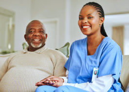 female caretaker and elderly man smiling