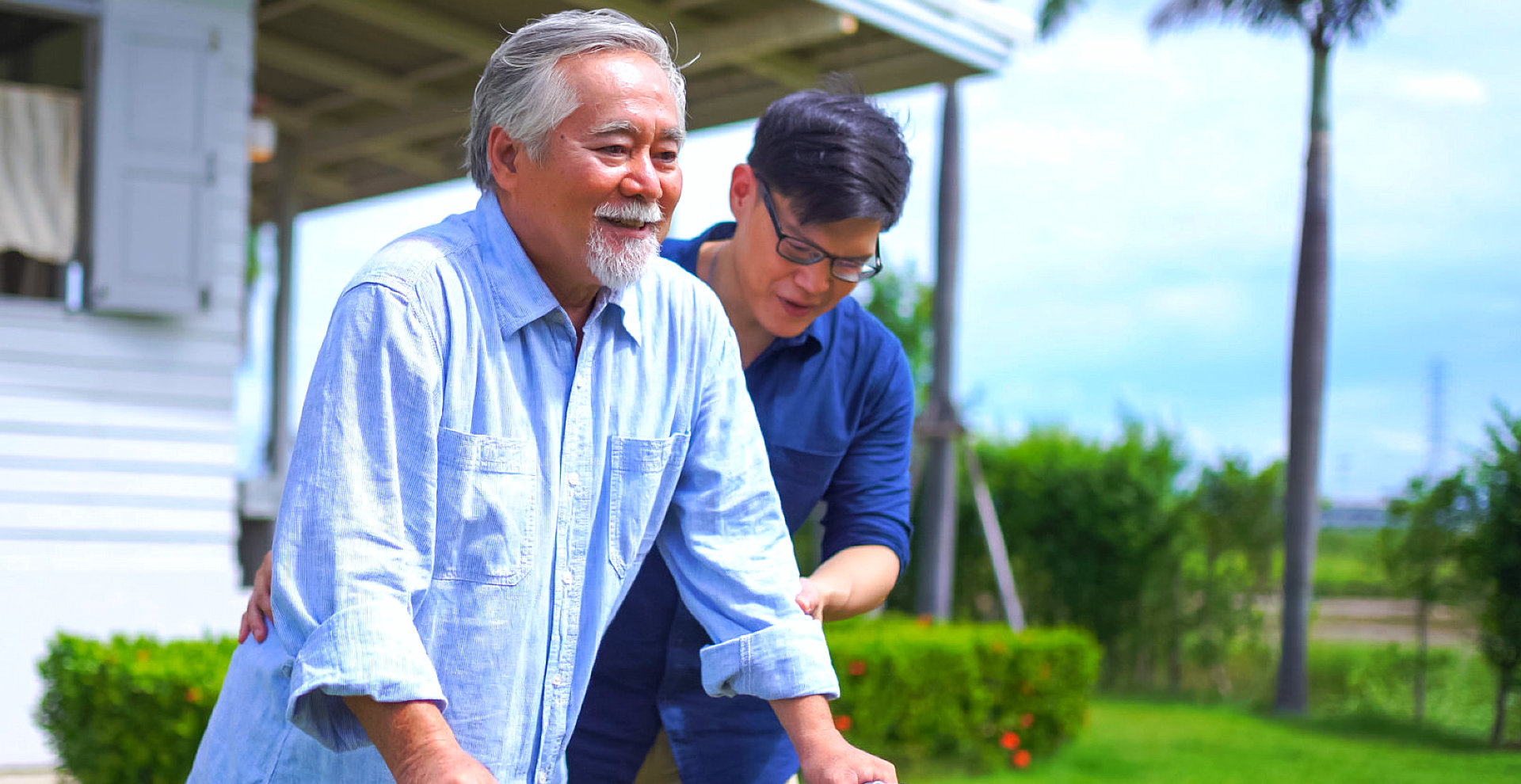male caretaker helps the elderly man
