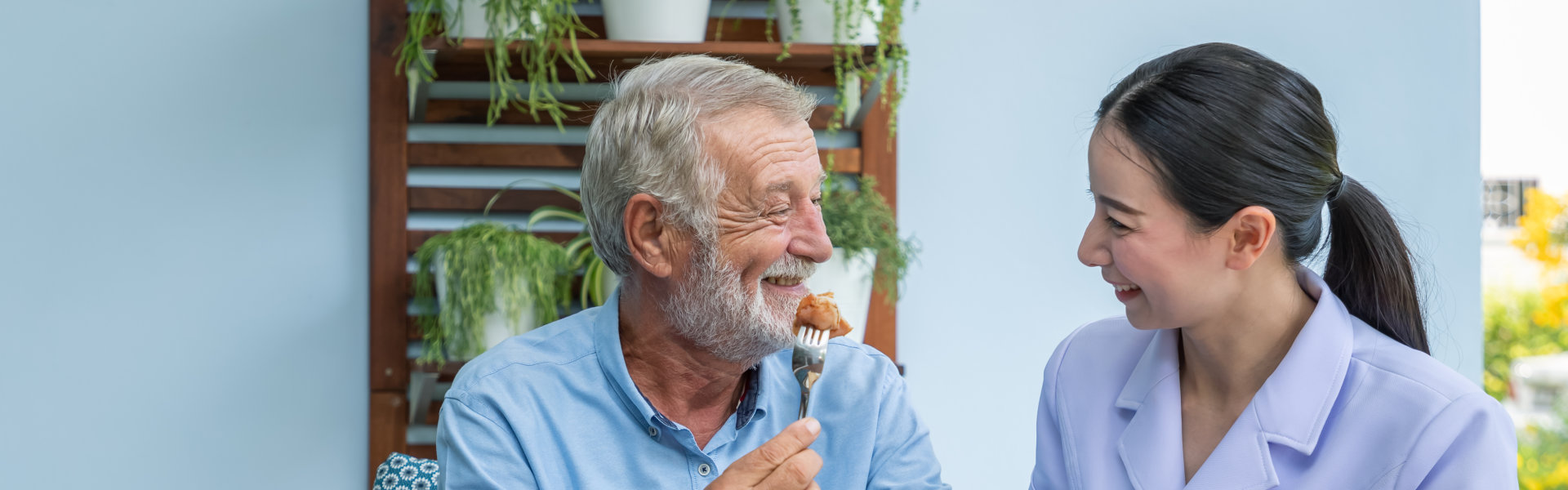 aide and elderly man smiling