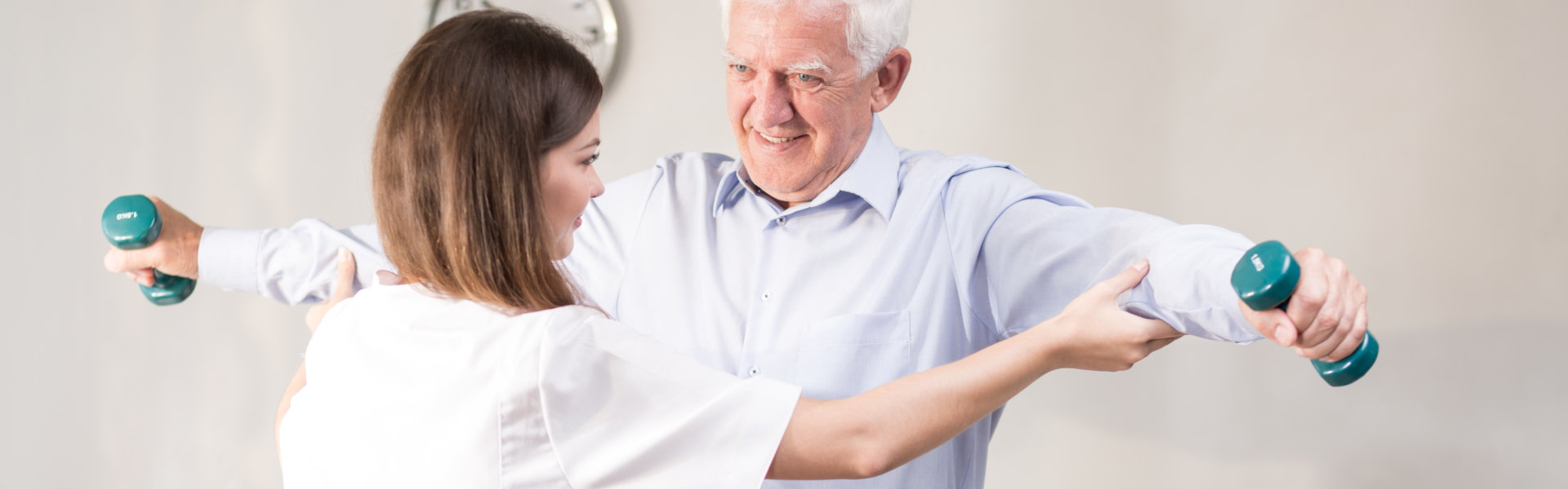 aide assisting an elderly man in exercising